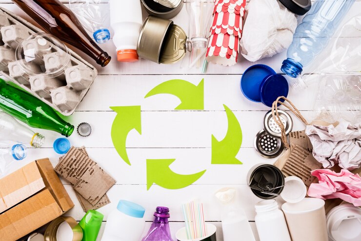 Kuva different garbage materials with recycling symbol