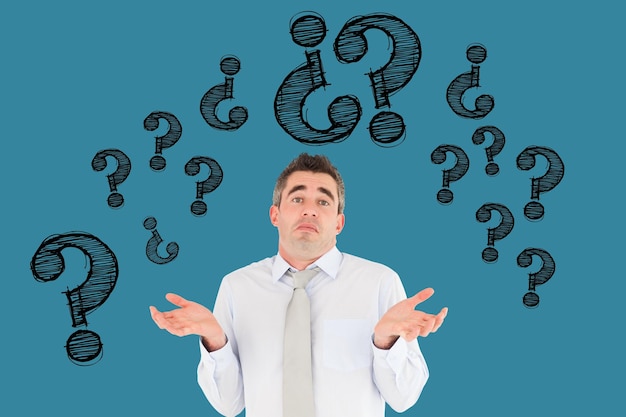 Digital composite image of confused businessman with question marks flying against blue background