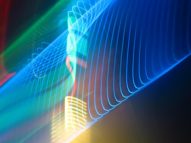 Digital composite image of light trails against black background