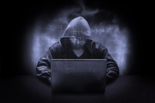 Digital composite image of man using laptop on table