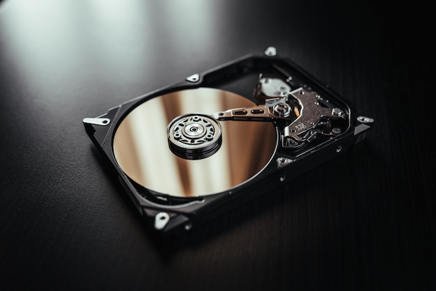 Disassembled hard drive from the computer, hdd with mirror effects. Part of computer pc, laptop