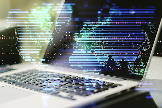 Double exposure of abstract digital world map on laptop background research and strategy concept