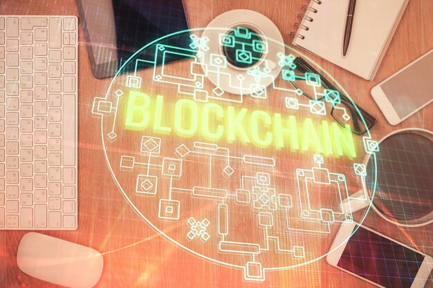 Double exposure of blockchain theme hologram over table with phone Top view Crypto technology concept