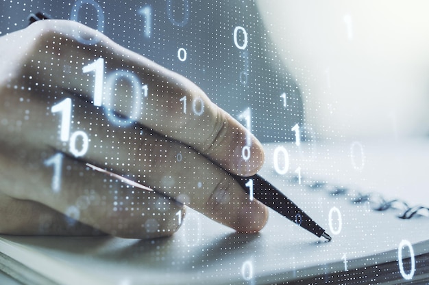 Double exposure of creative abstract binary code hologram and man hand writing in notebook on background Database and programming concept
