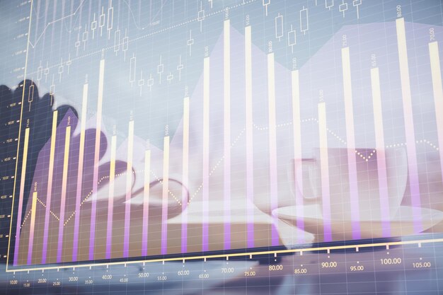 double exposure of financial chart drawing and desktop with coffee and items on table background concept of forex market trading