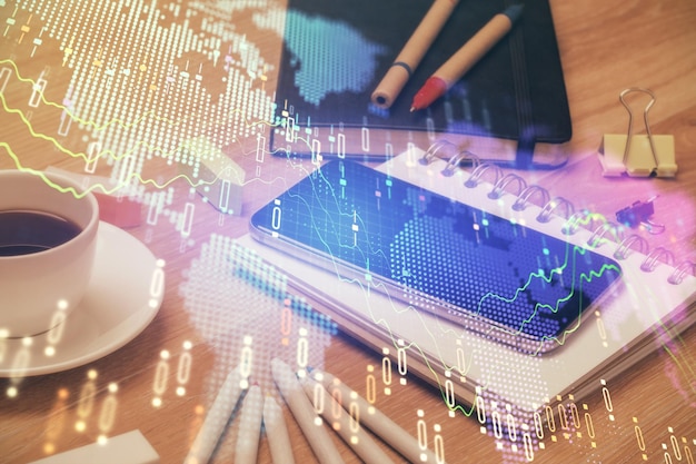 Double exposure of forex chart drawing and cell phone background Concept of financial trading