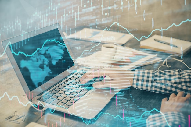 Double exposure of forex chart with man working on computer on background Concept of market analysis