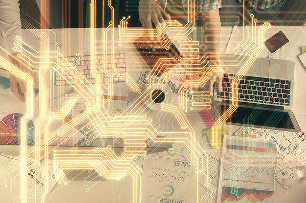 Double exposure of man and woman working together and tech hologram drawing Technology concept Computer background