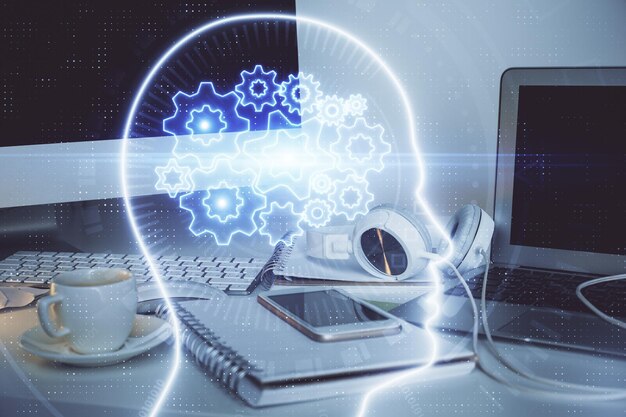 double exposure of table with computer and brain hologram data innovation concept
