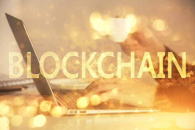 Double exposure of woman hands typing on computer and crypto market theme hologram drawing Blockchain concept