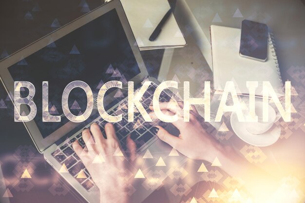 Double exposure of woman hands typing on computer and crypto market theme hologram drawing Blockchain concept