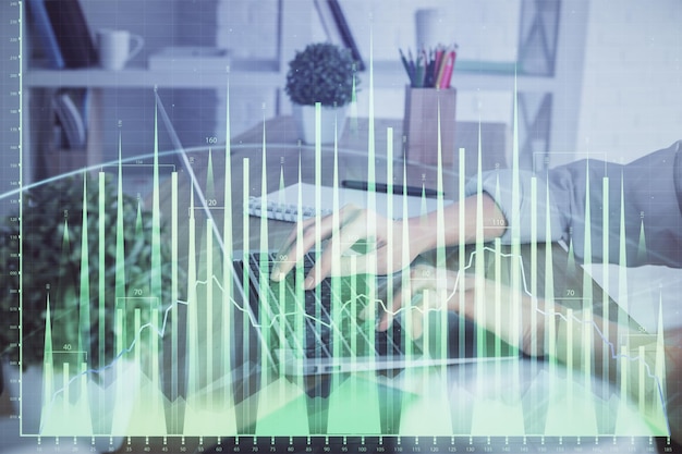 Double exposure of woman hands typing on computer and forex chart hologram drawing Stock market invest concept
