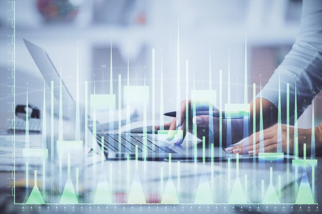 Double exposure of woman hands typing on computer and forex chart hologram drawing Stock market invest concept