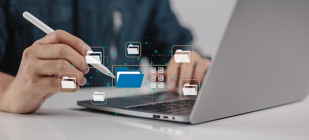 Edocumentbased paperless office concept A businessman types on a laptop while seeing document icons