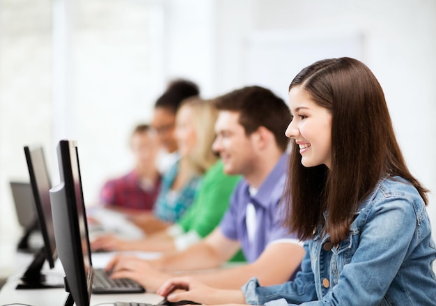 education, technology and internet - students with computers studying at school