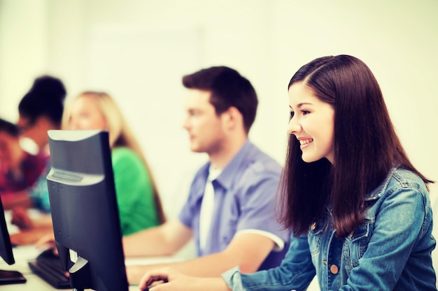 education, technology and internet - students with computers studying at school