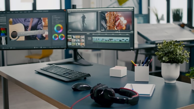 empty creative multimedia studio with professional computer placed on desk dual monitor setup video ...