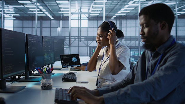 Engineer arriving in data center saluting colleagues