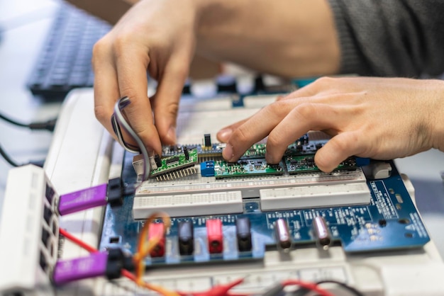 Engineer hold circuit or silicon chip in his workplace b