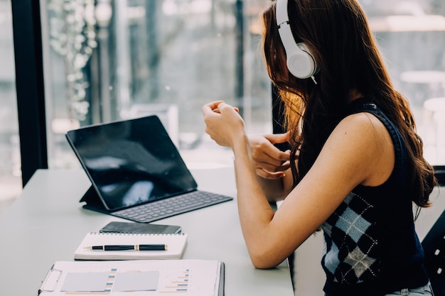 Entrepreneur Asian businessman and businesswoman discussing new business project in tablet in modern Meeting In Modern Office Asian business casual concept