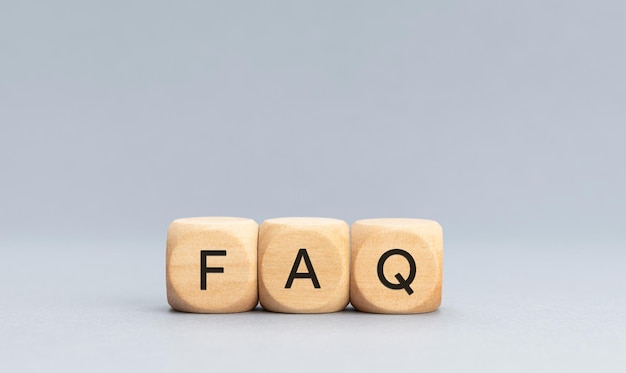 FAQ or Frequently Asked Questions concept Text on Wooden block shape on gray background Copy space