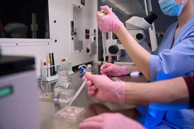 Female embryologist conducting a precision lab process