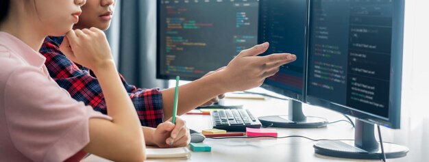 Female programer explain while pointing code displayed on computer Professional programmer present data analysis and writing java script at modern company office Closeup Burgeoning