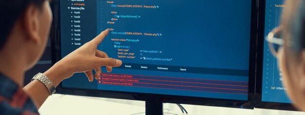 Female programer explain while pointing code displayed on computer Professional programmer present data analysis and writing java script at modern company office Closeup Burgeoning