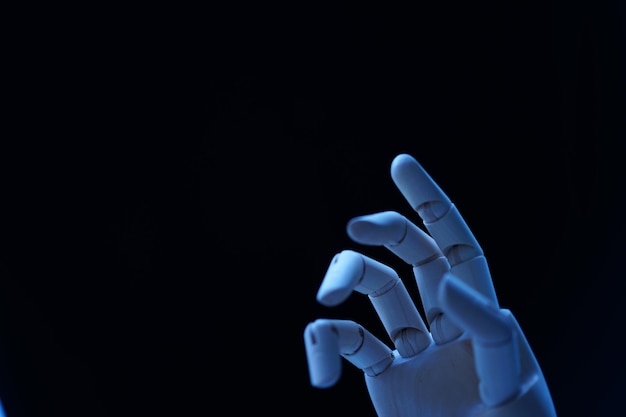 Figurine hand against black background