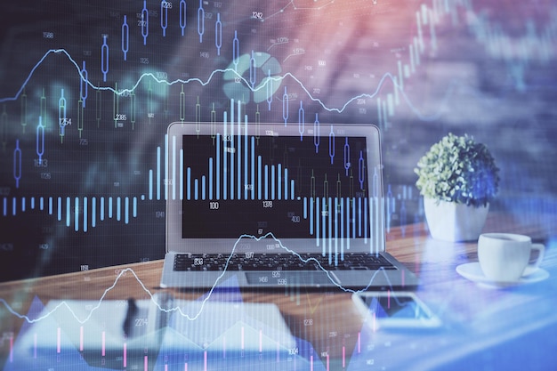 Financial chart drawing and table with computer on background Multi exposure Concept of international markets