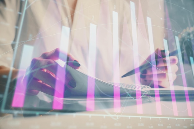 financial chart drawn over hands taking notes background concept of research multi exposure