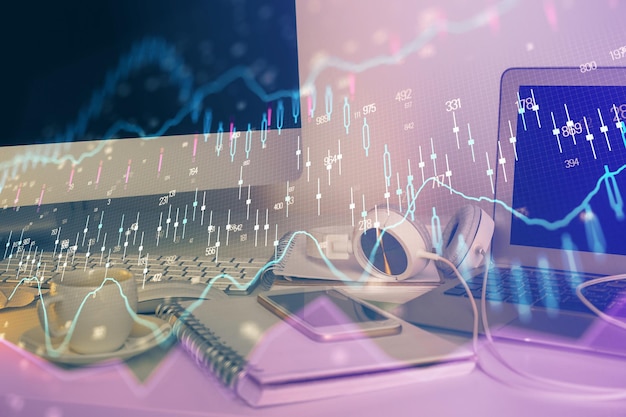 Financial graph colorful drawing and table with computer on background Multi exposure Concept of international markets