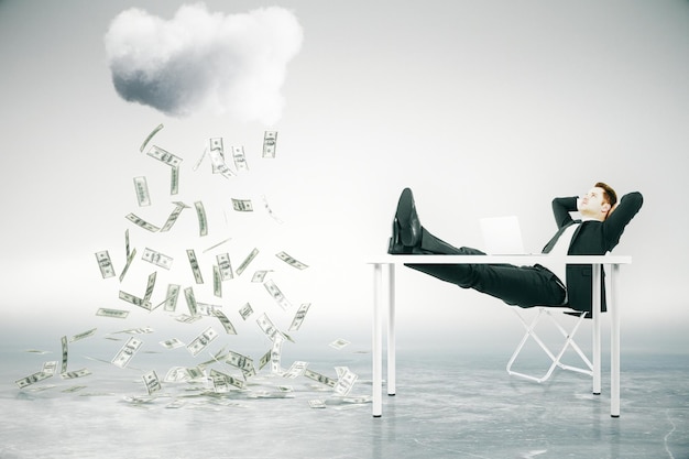 financial growth concept with businessman sitting at table with feet up and looking at abstract money rain 3d rendering
