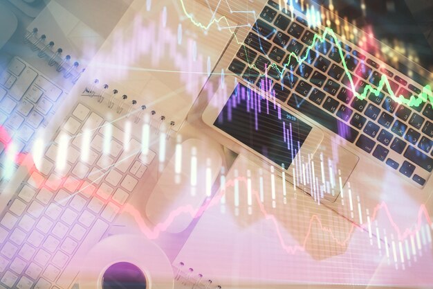 Financial market graph and top view computer on the desktop background Multi exposure Investment concept