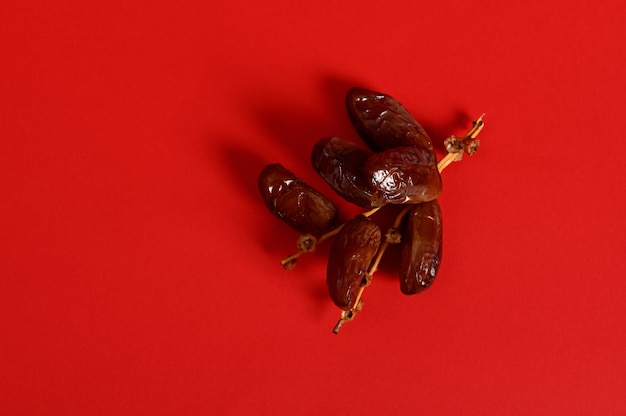 flat lay composition with a branch of fresh tasty sweet dates for breakfast after interruption and fasting in ramadan