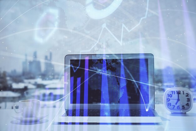 forex graph hologram on table with computer background multi exposure concept of financial markets
