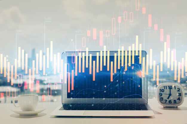 Forex graph hologram on table with computer background Multi exposure Concept of financial markets