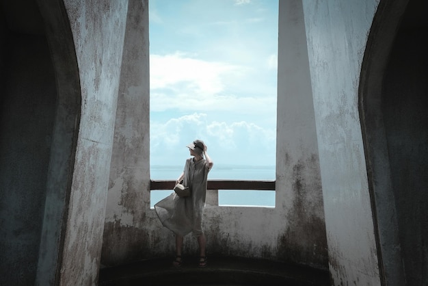 Full length of fashionable woman standing in abandoned building