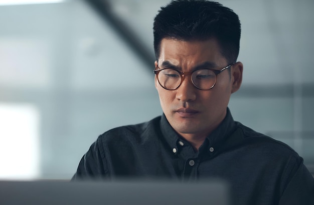 Glasses focus and professional male attorney working on a law case with computer in workplace