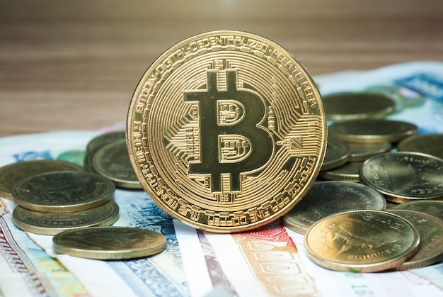Gold bit coins placed on banknotes.