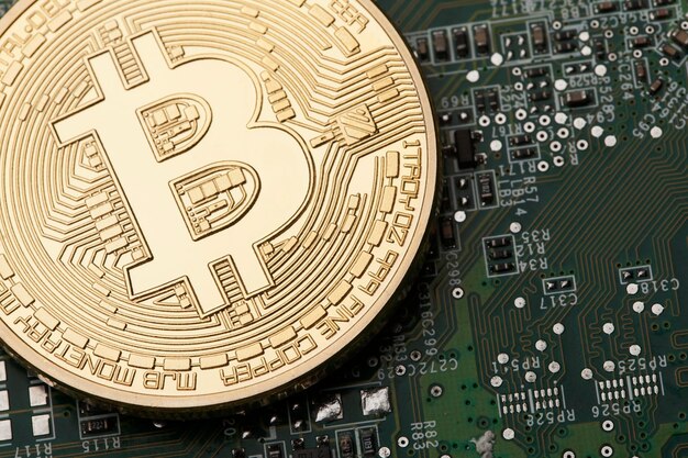 Golden Bitcoin virtual currency on a circuit board background