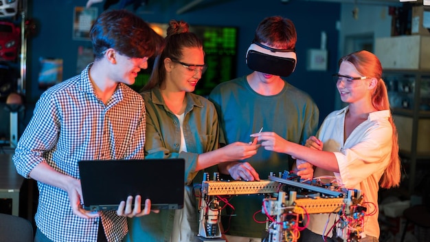 Group of teens doing experiments in robotics in a laboratory Boys and girls in protective and VR