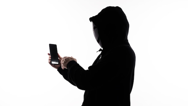 hacker anonymous and face mask with smartphone in hand