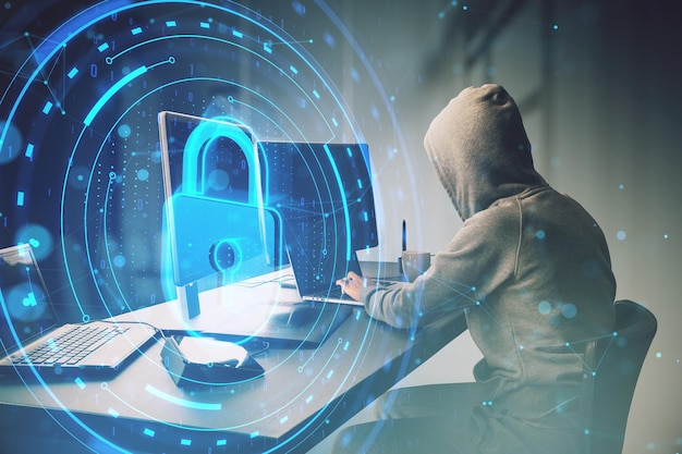 Hacker at desk using laptop with creative round digital padlock interface on blurry background Safety security hacking and data protection concept Side view Double exposure