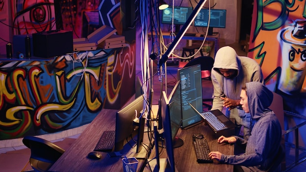 Hacker group coordinating DDoS attack on website sending large amounts of traffic from multiple sources to overwhelm it Rogue programmers working together to flood target server slowing it down