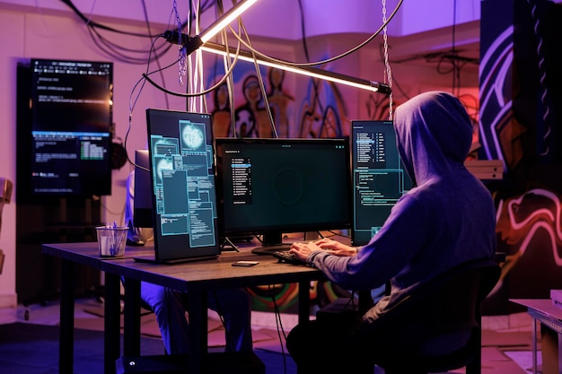 Hacker in hood using spyware