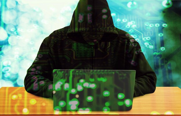 Hacker using laptop. Hacking the Internet.