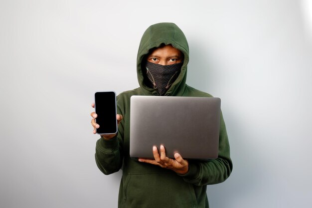 Hacker using laptop to steal personal data from people and calling someone to request a ransom isolated on white background