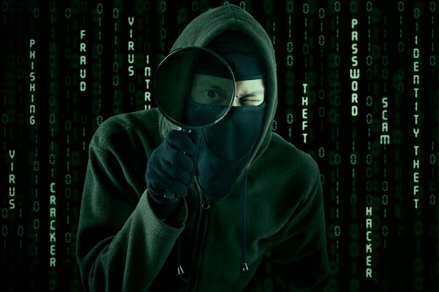 Hacker using magnifying glass
