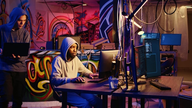 Hacking group leader teaching new member how to code malware designed to exploit network backdoors Script kiddie learns how to bypass security measures such as logins and password protections